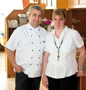 a man and a woman standing in a kitchen at Hotel Gasthof Rössle in Rottenburg