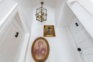 a picture of a man on a wall with a mirror at Sintra1012 Boutique Guesthouse in Sintra