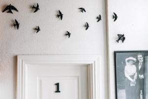 a group of birds hanging on a wall at Sintra1012 Boutique Guesthouse in Sintra