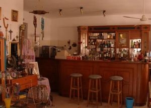 a bar with two stools in a room at Hotel Alexandros in Ormos Panagias