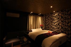 Voodi või voodid majutusasutuse ホテルオリジン Hotel Origin 男塾ホテルグループ toas