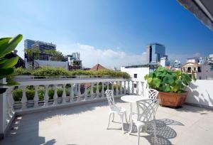 a balcony with two chairs and a table on a building at Babylon D3 Serviced Apartment in Ho Chi Minh City