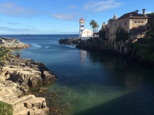 a river with a light house and a lighthouse at modern flat in Estoril