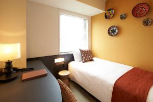 A bed or beds in a room at DEL style Osaka Higashi Temma by Daiwa Roynet Hotel