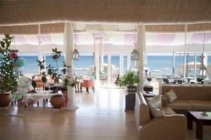 a living room with a view of the ocean at Sacallis Inn Beach Hotel in Kefalos
