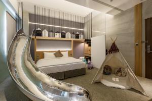 a bedroom with a bed and a tub in it at Green Hotel in Magong