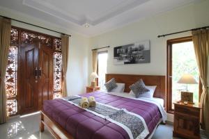 Postel nebo postele na pokoji v ubytování Jempiring Homestay