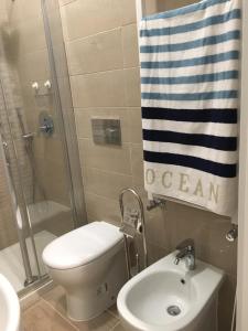 a bathroom with a toilet and a sink and a shower at Albamare in Monterosso al Mare
