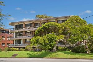 an apartment building with a tree in front of it at Quarterdeck 7 7 Stewart Street in Port Macquarie