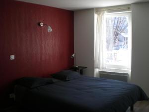 Postel nebo postele na pokoji v ubytování Appart Hotel de la Paix