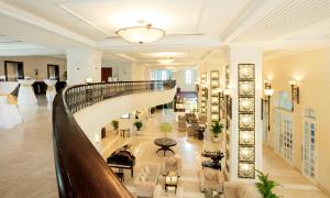 a large lobby with a spiral staircase in a building at Sunrise Nha Trang Beach Hotel & Spa in Nha Trang