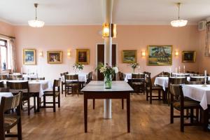 a dining room with tables and chairs and candles at Hotel Inger in Hulsig