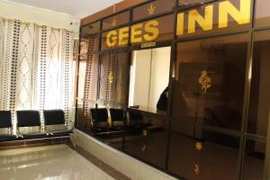 a dressing room with chairs and a sign that says getsini at Gees Inn in Nakuru