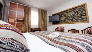 En eller flere senge i et værelse på LAL Hotel