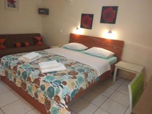 a bedroom with a bed and a couch at Nicolas Studios & Apartments in Agia Marina Nea Kydonias