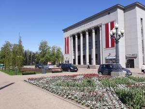 a building with a flower bed in front of it at Town Center Studio Apartment in Daugavpils