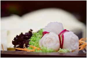 a plate of food with shrimp and vegetables on it at Motel Plus Berlin in Berlin