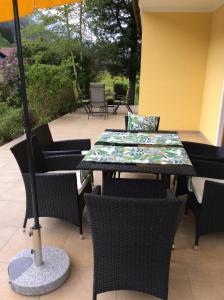 a table and chairs with an umbrella on a patio at Haus Mup in Spittal an der Drau