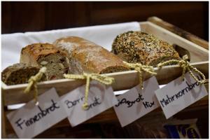 a crate of breads sitting on top of a table at Motel Plus Berlin in Berlin