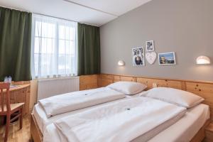 Un ou plusieurs lits dans un hébergement de l'établissement JUFA Hotel Bad Aussee