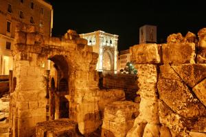un edificio con un arco in una città di notte di Li Frati Casa Vacanze a Lecce