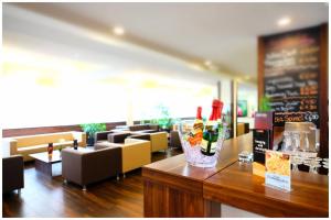 a restaurant with a counter with bottles of wine on it at Motel Plus Berlin in Berlin