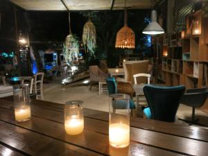 two candles sitting on a wooden table in a restaurant at Gorgona Studios in Faliraki