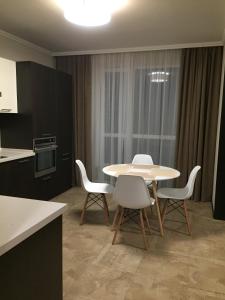 a kitchen with a table and chairs in a room at Apartment Viva in Kyiv