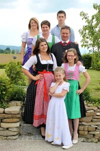 a group of people in dresses posing for a picture at Pension Merkinger in Behamberg