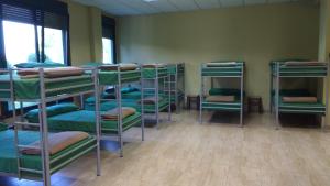 a group of bunk beds in a room at Albergue Los Caminantes 2 in Arzúa