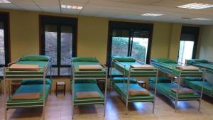 a group of bunk beds in a room at Albergue Los Caminantes 2 in Arzúa