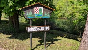 un cartel en un parque con una casa de pájaros en Vila Viktorija en Brod na Kupi