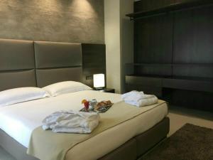 una camera da letto con un letto con due asciugamani sopra di Plus Welcome Milano a Milano