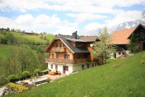 a large house on top of a hill at Appartement Steinacher in Schladming