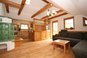 a living room with a couch and a table at Appartement Steinacher in Schladming