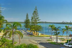 a view of a parking lot with palm trees and the water at Macquarie Towers 17 1 Waugh Street in Port Macquarie
