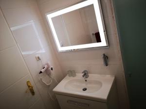 y baño con lavabo y espejo. en Ferienappartement in St. Margarethen, en Sankt Margarethen im Burgenland