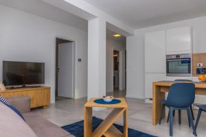a living room with a couch and a table at Apartment Di Blu in Novi Vinodolski