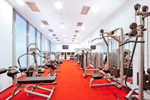 a gym with rows of treadmills and machines at Roset Hotel & Residence in Bratislava