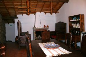 a dining room with a table and a fireplace at Quinta de la Barandica in Miranda do Douro