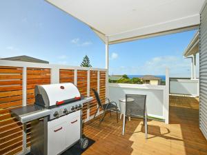 a patio with a grill and a table and chairs at Boomer Beach Retreat - Pet-Friendly - WiFi in Port Elliot