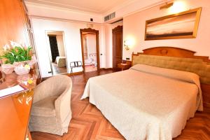 A bed or beds in a room at Palazzo Rosenthal Vesuview Hotel & Resort