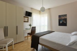 Postel nebo postele na pokoji v ubytování Vialeromadodici Rooms & Apartments