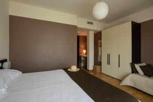 Postel nebo postele na pokoji v ubytování Vialeromadodici Rooms & Apartments