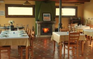 a dining room with tables and a fire place at HOSTAL Restaurante RANCHEIRO in Vigo