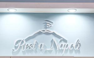 a sign for a shop with a hanger and text rest a market at B&B Rest a Napoli in Naples