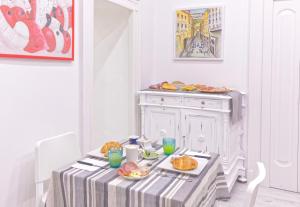 a table with plates of food on top of it at B&B Rest a Napoli in Naples