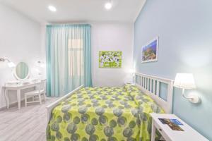 a bedroom with a bed and a desk and a sink at B&B Rest a Napoli in Naples
