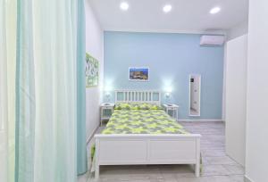 a bedroom with a bed in a white room at B&B Rest a Napoli in Naples
