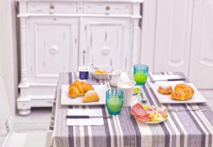 a table with two plates of pastries and drinks on it at B&B Rest a Napoli in Naples